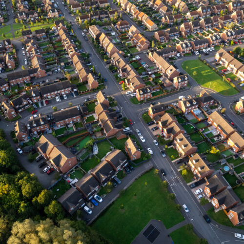 Top down aerial view of houses and streets in a residential area UK New Build Estate Agent House Prices 2022